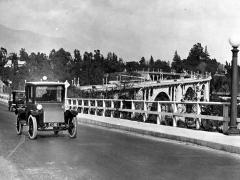 Black and white photo of vintage automobile on Colorado Street bridge