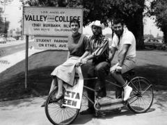 	Photograph caption dated May 18, 1959 reads, "Drumming up votes for Fiesta Queen and King at Valley College are, from left, Nancy McQuattie, Don Lemos and Foss Lasdon, members of Ski Lions.  Other campaigning was done via horseback, marching bands and floating balloons.  King, queen, four princes and four princesses will be crowned at college Fiesta Dance at 10 p.m. today."