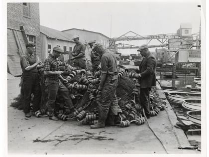 Fishermen mending fish nets, East San Pedro, Los Angeles Harbor district, General Subjects Photography Collection